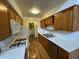 Traditional kitchen featuring wooden cabinets, white counters, and tile backsplash with gas burning stove at 4953 Mccray St, Indianapolis, IN 46224