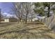 Large backyard with trees, an area for entertainment, and a fence line at 4953 Mccray St, Indianapolis, IN 46224