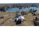 Scenic aerial view of a lakeside property featuring a home, large barn, and waterfront access at 5420 W Goeller W Rd, Columbus, IN 47201