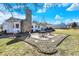 Charming backyard patio area with stone accents, perfect for outdoor dining and relaxation, surrounded by lush greenery at 5420 W Goeller W Rd, Columbus, IN 47201
