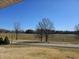 Scenic backyard view of a large, grassy lawn, pond and the surrounding trees at 5420 W Goeller W Rd, Columbus, IN 47201