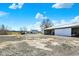 Spacious farm property featuring white barn buildings against a blue sky at 5420 W Goeller W Rd, Columbus, IN 47201