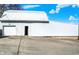Side view shows exterior of barn with a garage door and entry door at 5420 W Goeller W Rd, Columbus, IN 47201
