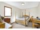 Bright bedroom with natural light, a four poster bed and a functional desk area at 5420 W Goeller W Rd, Columbus, IN 47201