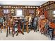 Unique bonus room showcases wooden walls, saddles and handcrafted decor, offering a distinctive and rustic charm at 5420 W Goeller W Rd, Columbus, IN 47201