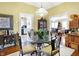 Inviting dining room with a glass table, decorative chandelier and warm, neutral color palette at 5420 W Goeller W Rd, Columbus, IN 47201