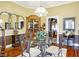 Formal dining room with glass table and ornate mirror is perfect for entertaining at 5420 W Goeller W Rd, Columbus, IN 47201