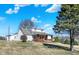 Quaint home with a brick-accented porch, siding, a well-maintained lawn, and a mature tree at 5420 W Goeller W Rd, Columbus, IN 47201