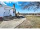 Charming front entrance with white siding, leading to a beautifully landscaped yard and surrounding greenery at 5420 W Goeller W Rd, Columbus, IN 47201