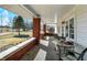 Inviting front porch with red brick columns, offering a cozy outdoor seating area and ample natural light at 5420 W Goeller W Rd, Columbus, IN 47201