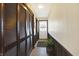 Hallway features dark wood closet doors and trim, with tile flooring at 5420 W Goeller W Rd, Columbus, IN 47201