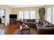 Comfortable living room with a large sectional sofa, hardwood floors, and a view into the kitchen, perfect for entertaining at 5420 W Goeller W Rd, Columbus, IN 47201