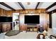 Inviting living room boasts wood paneling, beamed ceilings, and cozy decor, creating a warm and rustic atmosphere at 5420 W Goeller W Rd, Columbus, IN 47201