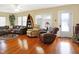 Bright living room with hardwood floors, comfortable seating, and a boat-shaped bookshelf, creating a relaxing atmosphere at 5420 W Goeller W Rd, Columbus, IN 47201