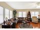 Inviting living room featuring a large sectional sofa, hardwood floors, and ample natural light, creating a cozy atmosphere at 5420 W Goeller W Rd, Columbus, IN 47201