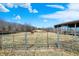 Scenic pasture with sturdy fencing, a rustic barn, and a grazing horse, offering a tranquil rural setting at 5420 W Goeller W Rd, Columbus, IN 47201