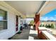 Covered porch with brick columns, outdoor seating, and a view of the front yard at 5420 W Goeller W Rd, Columbus, IN 47201