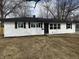 Charming single-story home with a freshly painted white exterior and black accents on a sunny, winter day at 5546 Marilyn Rd, Indianapolis, IN 46226