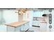 Bright kitchen showcasing white cabinetry, butcher block island, subway tile backsplash, and modern lighting at 5546 Marilyn Rd, Indianapolis, IN 46226