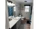 Well-lit bathroom with a single vanity, toilet, and shower with shark-themed curtain at 5700 S 100 W, Pendleton, IN 46064