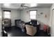 Neutral bedroom with a dark wood floor, ceiling fan, and lots of wall art at 5700 S 100 W, Pendleton, IN 46064