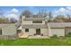 Spacious backyard featuring a small deck, sliding glass doors, and well-kept lawn at 5762 Overcrest Dr, Indianapolis, IN 46237