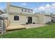 View of the home's backyard featuring a small wooden deck and sliding glass doors at 5762 Overcrest Dr, Indianapolis, IN 46237