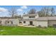 Beautiful lawn in this backyard featuring a small deck, sunroom, and sliding glass doors at 5762 Overcrest Dr, Indianapolis, IN 46237