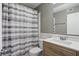 Well-lit bathroom featuring a vanity, toilet, and shower with stylish curtain at 5762 Overcrest Dr, Indianapolis, IN 46237