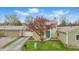Attractive home exterior featuring a stone chimney, blue front door, and vibrant tree at 5762 Overcrest Dr, Indianapolis, IN 46237