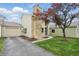 Charming home exterior with a stone chimney, a vibrant tree, and an attached garage at 5762 Overcrest Dr, Indianapolis, IN 46237