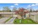 Inviting home exterior with attached garages, a stone chimney, and lush green lawn at 5762 Overcrest Dr, Indianapolis, IN 46237