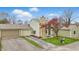 Home exterior with stone chimney, attached garage, and well-maintained lawn at 5762 Overcrest Dr, Indianapolis, IN 46237