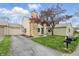 Eye-catching front exterior with stone chimney, tandem garage, and meticulously manicured front yard at 5762 Overcrest Dr, Indianapolis, IN 46237
