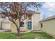 Inviting front exterior showcasing a stone facade, well-maintained lawn, and mature tree at 5762 Overcrest Dr, Indianapolis, IN 46237