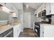 Updated kitchen features white cabinetry, stainless steel appliances, and durable countertops at 5762 Overcrest Dr, Indianapolis, IN 46237