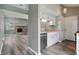 Modern kitchen with white cabinets and stainless steel appliances adjoins the living room at 5762 Overcrest Dr, Indianapolis, IN 46237