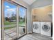 Bright laundry room area with a sliding glass door and natural light at 5762 Overcrest Dr, Indianapolis, IN 46237