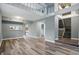 Open living area with luxury vinyl plank flooring, neutral paint, and staircase access at 5762 Overcrest Dr, Indianapolis, IN 46237