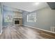 Bright living room featuring a stone fireplace, luxury vinyl plank flooring and natural light at 5762 Overcrest Dr, Indianapolis, IN 46237