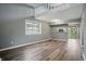 Spacious living area features luxury vinyl plank flooring, neutral paint, and a window at 5762 Overcrest Dr, Indianapolis, IN 46237
