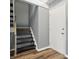 Basement entryway with wooden staircase, luxury vinyl plank flooring, and fresh paint at 5762 Overcrest Dr, Indianapolis, IN 46237