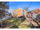Spacious backyard with a brick house, a well-maintained lawn and a cozy patio area at 6225 Indianola Ave, Indianapolis, IN 46220