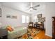 Serene bedroom with hardwood floors, a ceiling fan, natural light, and a comfortable bed at 6225 Indianola Ave, Indianapolis, IN 46220