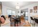 Bright dining area featuring a built-in bench, a view into the living room, and hardwood flooring at 6225 Indianola Ave, Indianapolis, IN 46220
