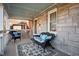 Relaxing front porch with stone walls, comfortable seating, and stylish rug creating an inviting outdoor space at 6225 Indianola Ave, Indianapolis, IN 46220