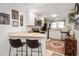 Efficient kitchen with white cabinets, stainless steel appliances, breakfast bar, and hardwood floors at 6225 Indianola Ave, Indianapolis, IN 46220