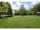 Expansive backyard featuring a large lawn with trees and a gazebo in the corner at 6459 Canak Dr, Avon, IN 46123