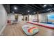 Finished basement featuring an open space with a play area and wood-look flooring at 6459 Canak Dr, Avon, IN 46123
