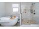 Bright bathroom featuring a soaking tub and marble tiled stand up shower at 6459 Canak Dr, Avon, IN 46123
